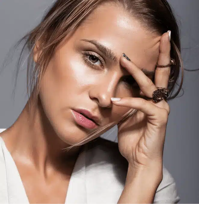 Portrait of a woman with subtle expression lines on her forehead and around her eyes, conveying natural signs of aging with radiant skin.